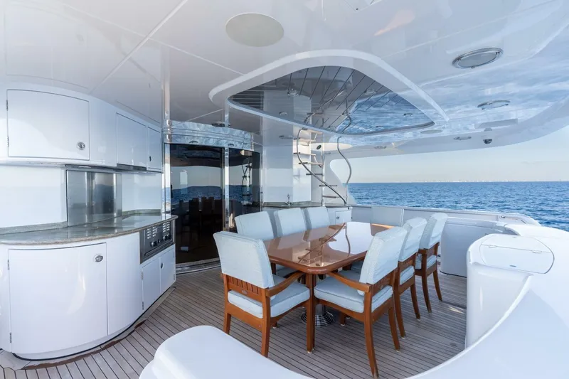 Ruffian Yacht Photos Pics Luxurious 2001 Delta Marine Tri-Deck yacht with elegant outdoor dining area and ocean view.