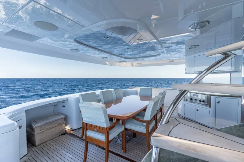 Ruffian Yacht Photos Pics Luxurious Delta Marine Tri-Deck yacht deck with dining area, ocean view, and modern amenities, 2001 model.