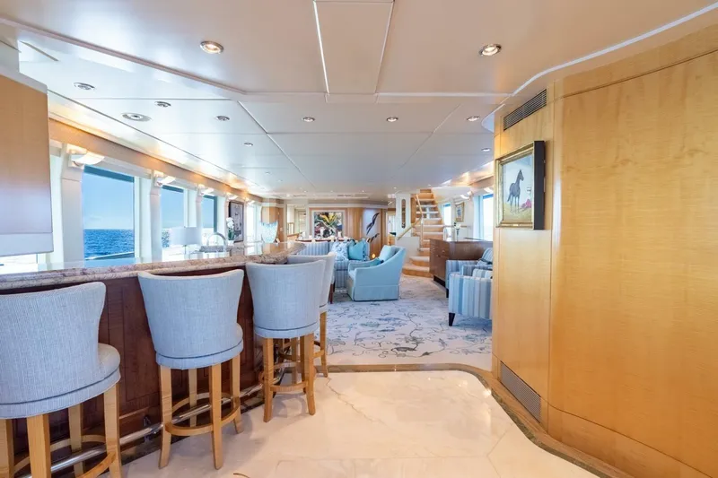 Ruffian Yacht Photos Pics Luxurious interior of 2001 Delta Marine Tri-Deck yacht with elegant seating and ocean views.