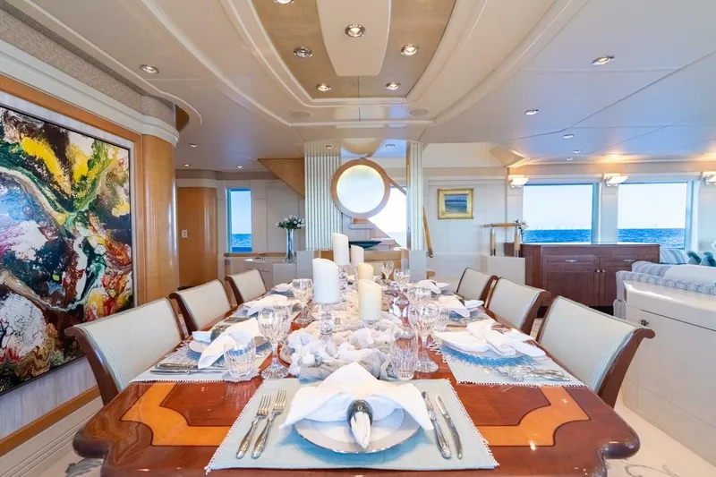 Ruffian Yacht Photos Pics Luxurious dining area on 2001 Delta Marine Tri-Deck yacht, featuring elegant table setting and ocean view.