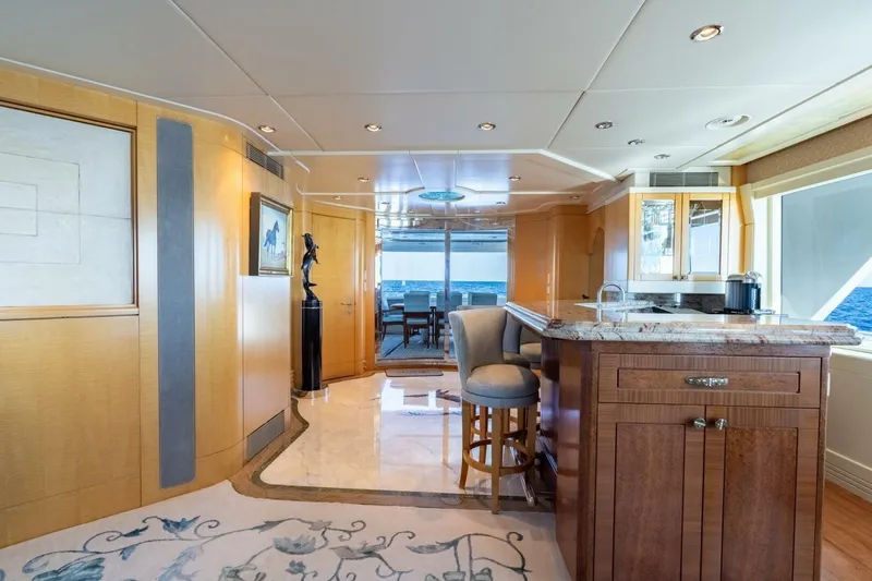 Ruffian Yacht Photos Pics Luxurious interior of 2001 Delta Marine Tri-Deck yacht with elegant bar and ocean view.