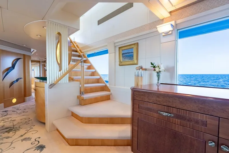 Ruffian Yacht Photos Pics Luxurious interior of 2001 Delta Marine Tri-Deck yacht with elegant staircase and ocean view.