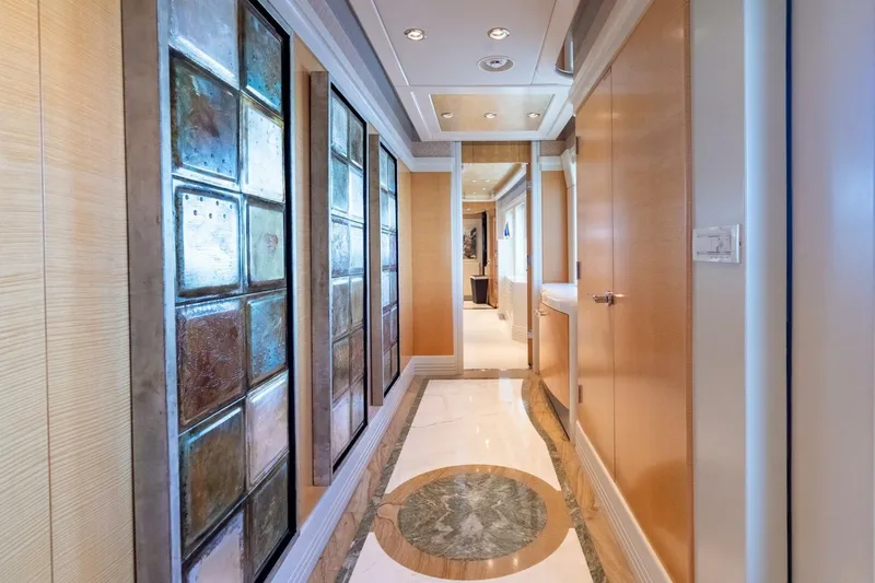 Ruffian Yacht Photos Pics Luxurious hallway on 2001 Delta Marine Tri-Deck yacht with elegant wood and glass paneling.