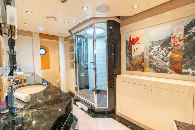 Ruffian Yacht Photos Pics Luxurious bathroom on 2001 Delta Marine Tri-Deck yacht with marble countertops and modern shower.