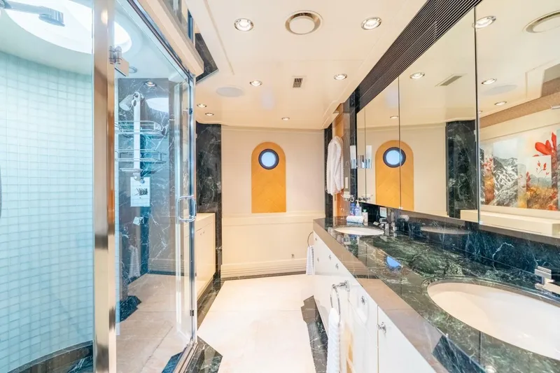 Ruffian Yacht Photos Pics Luxurious bathroom on 2001 Delta Marine Tri-Deck yacht with marble countertops and glass shower.