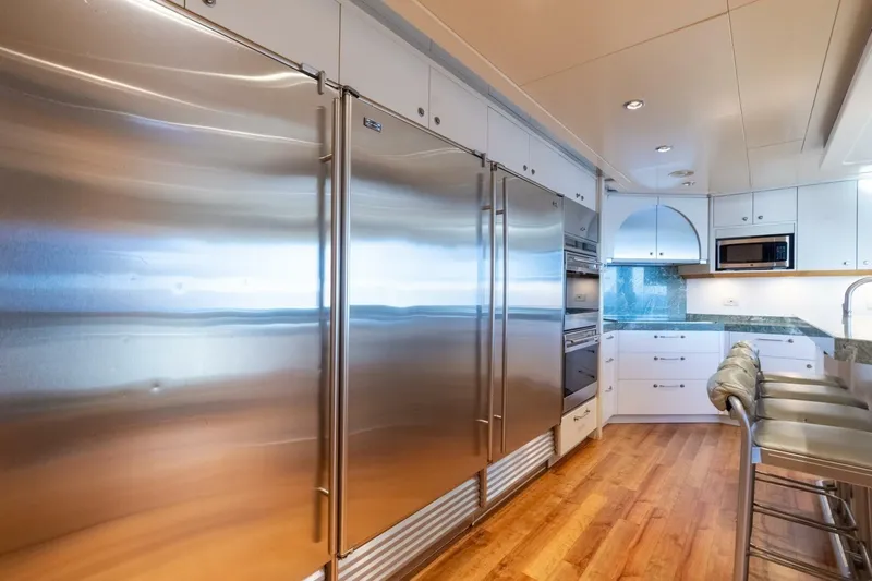 Ruffian Yacht Photos Pics Luxurious kitchen on 2001 Delta Marine Tri-Deck yacht with stainless steel appliances and modern design.