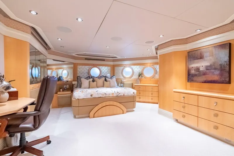 Ruffian Yacht Photos Pics Luxurious bedroom interior on 2001 Delta Marine Tri-Deck yacht, featuring elegant wood furnishings.