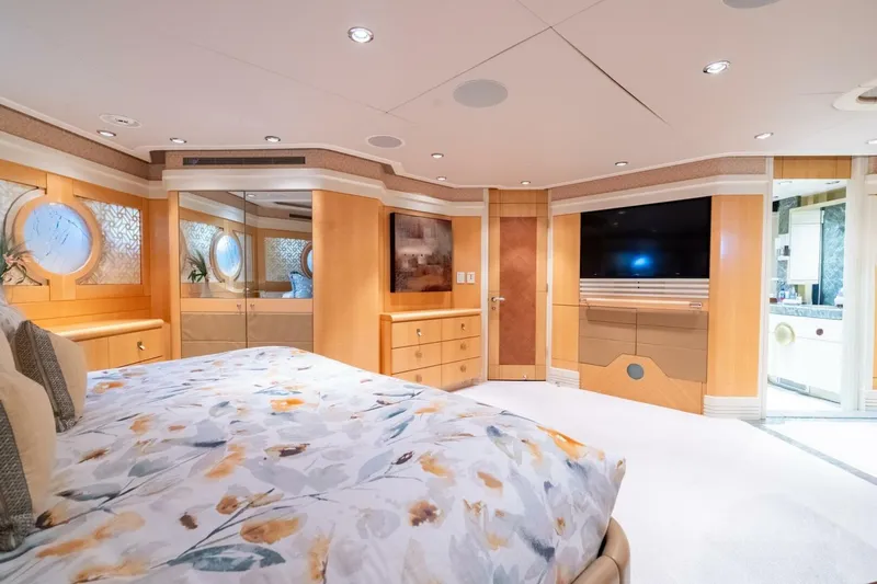 Ruffian Yacht Photos Pics Luxurious bedroom interior on 2001 Delta Marine Tri-Deck yacht, featuring elegant wood finishes and modern amenities.