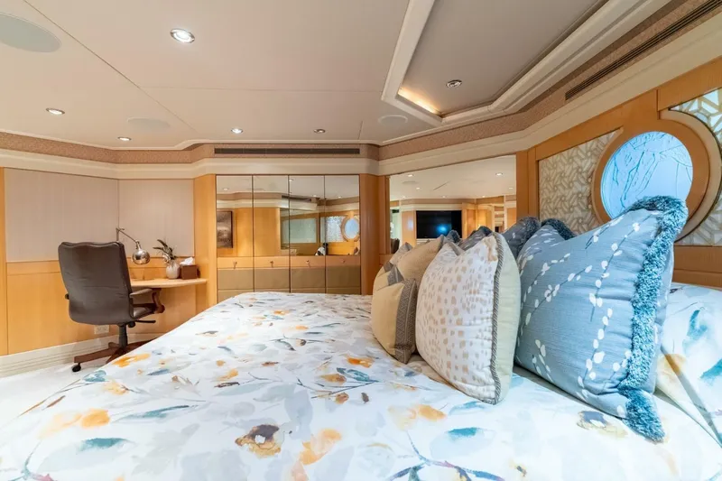Ruffian Yacht Photos Pics Luxurious bedroom on 2001 Delta Marine Tri-Deck yacht with elegant decor and plush bedding.