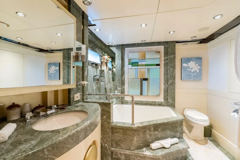 Ruffian Yacht Photos Pics Luxurious bathroom on 2001 Delta Marine Tri-Deck yacht with marble finishes and modern decor.