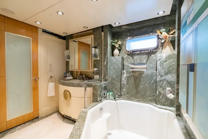 Ruffian Yacht Photos Pics Luxurious bathroom on 2001 Delta Marine Tri-Deck yacht with marble accents and modern fixtures.