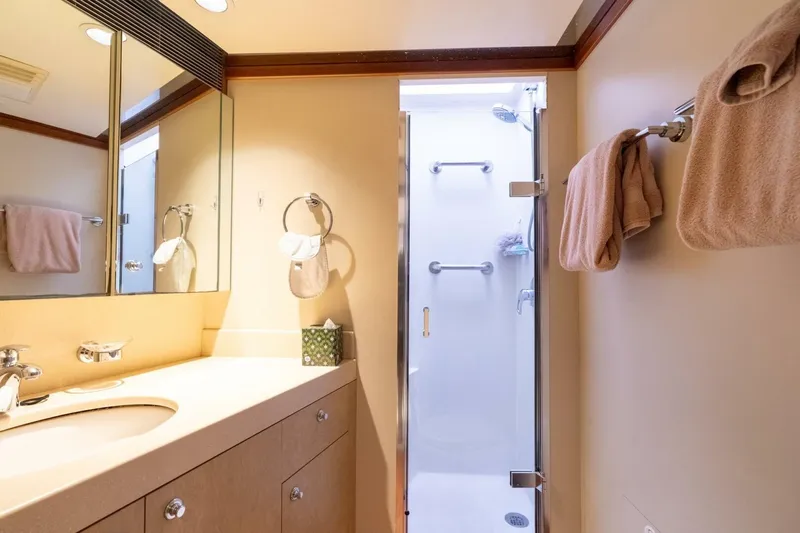 Ruffian Yacht Photos Pics Luxurious bathroom on 2001 Delta Marine Tri-Deck yacht with shower and vanity.