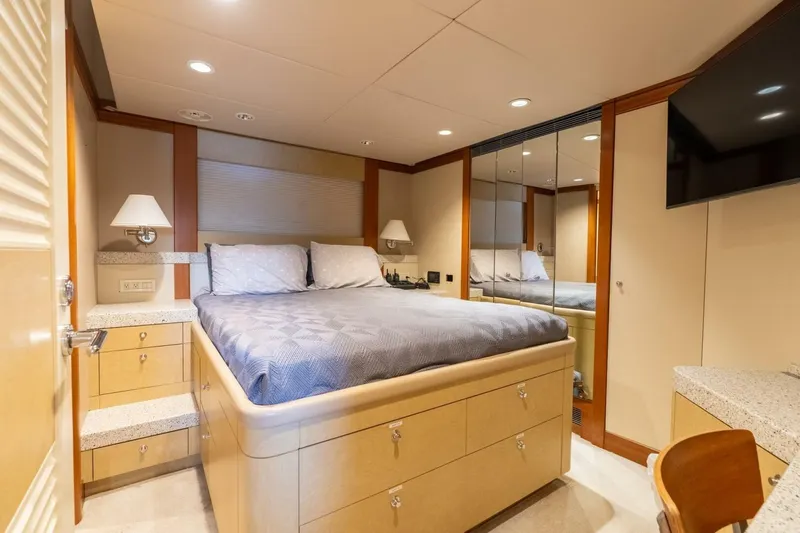 Ruffian Yacht Photos Pics Luxurious bedroom interior on 2001 Delta Marine Tri-Deck yacht, featuring elegant furnishings and modern amenities.