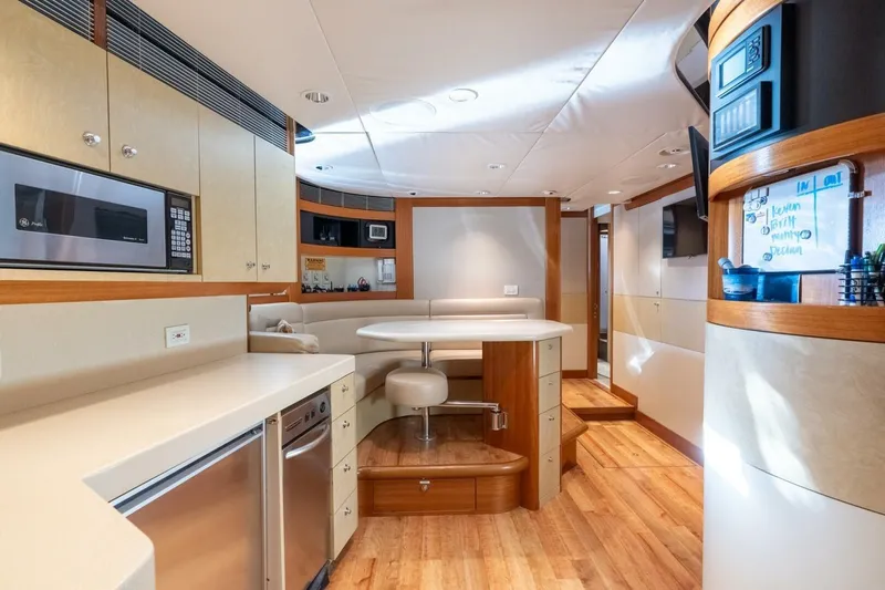 Ruffian Yacht Photos Pics Luxurious 2001 Delta Marine Tri-Deck yacht interior with modern kitchen and dining area.