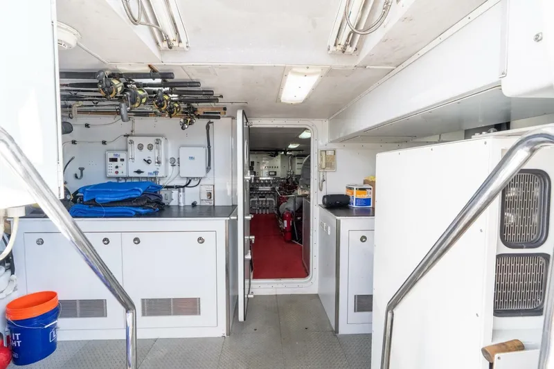 Ruffian Yacht Photos Pics Engine room of 2001 Delta Marine Tri-Deck yacht with equipment and storage.