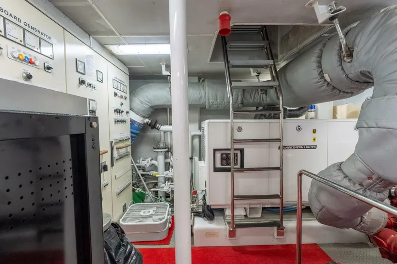 Ruffian Yacht Photos Pics Engine room of 2001 Delta Marine Tri-Deck yacht with control panels and machinery.