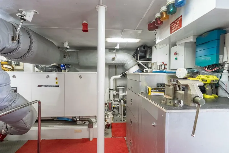 Ruffian Yacht Photos Pics Engine room of 2001 Delta Marine Tri-Deck yacht with equipment and tools.