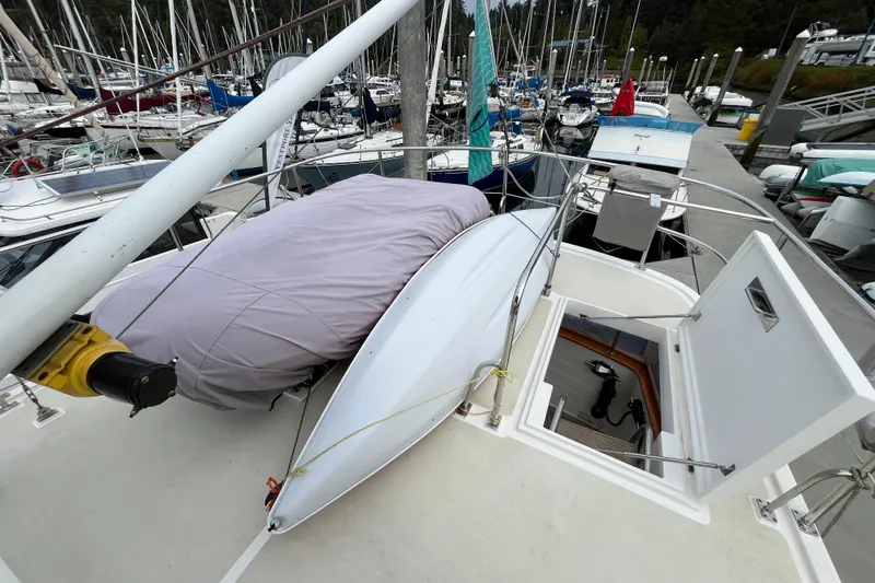 Abina Yacht Photos Pics Kadey-Krogen 39 yacht deck, 2001 model, with covered equipment and open hatch in marina.