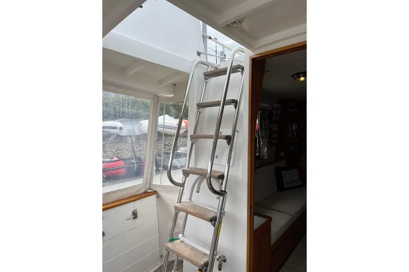 Abina Yacht Photos Pics Interior view of 2001 Kadey-Krogen 39 yacht with metal ladder and seating area.