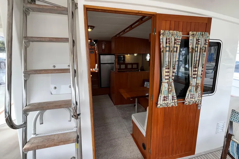 Abina Yacht Photos Pics Interior view of 2001 Kadey-Krogen 39 yacht, featuring wooden decor and compact living space.