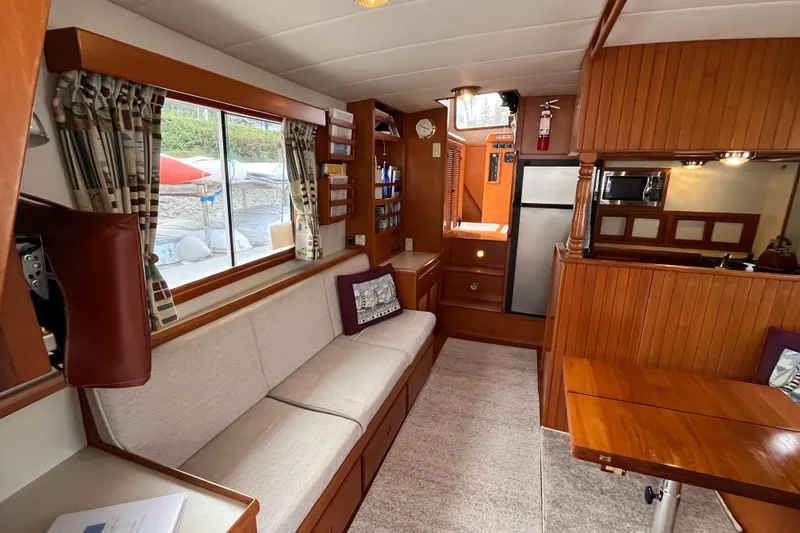 Abina Yacht Photos Pics Interior of 2001 Kadey-Krogen 39 yacht with cozy seating and wooden finishes.