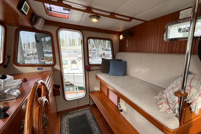Abina Yacht Photos Pics Cozy interior of 2001 Kadey-Krogen 39 yacht with plush seating and wooden accents.