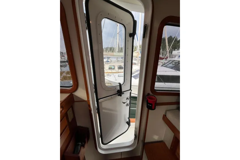 Abina Yacht Photos Pics Open cabin door on 2001 Kadey-Krogen 39 yacht, revealing marina view.