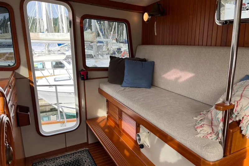 Abina Yacht Photos Pics Interior of 2001 Kadey-Krogen 39 yacht with cozy seating and marina view.