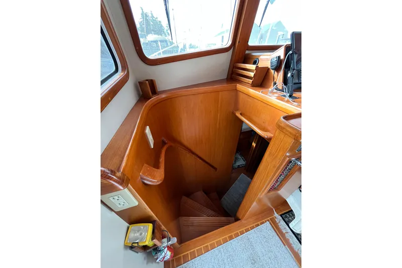 Abina Yacht Photos Pics Interior view of 2001 Kadey-Krogen 39 yacht, featuring wooden stairs and helm area.