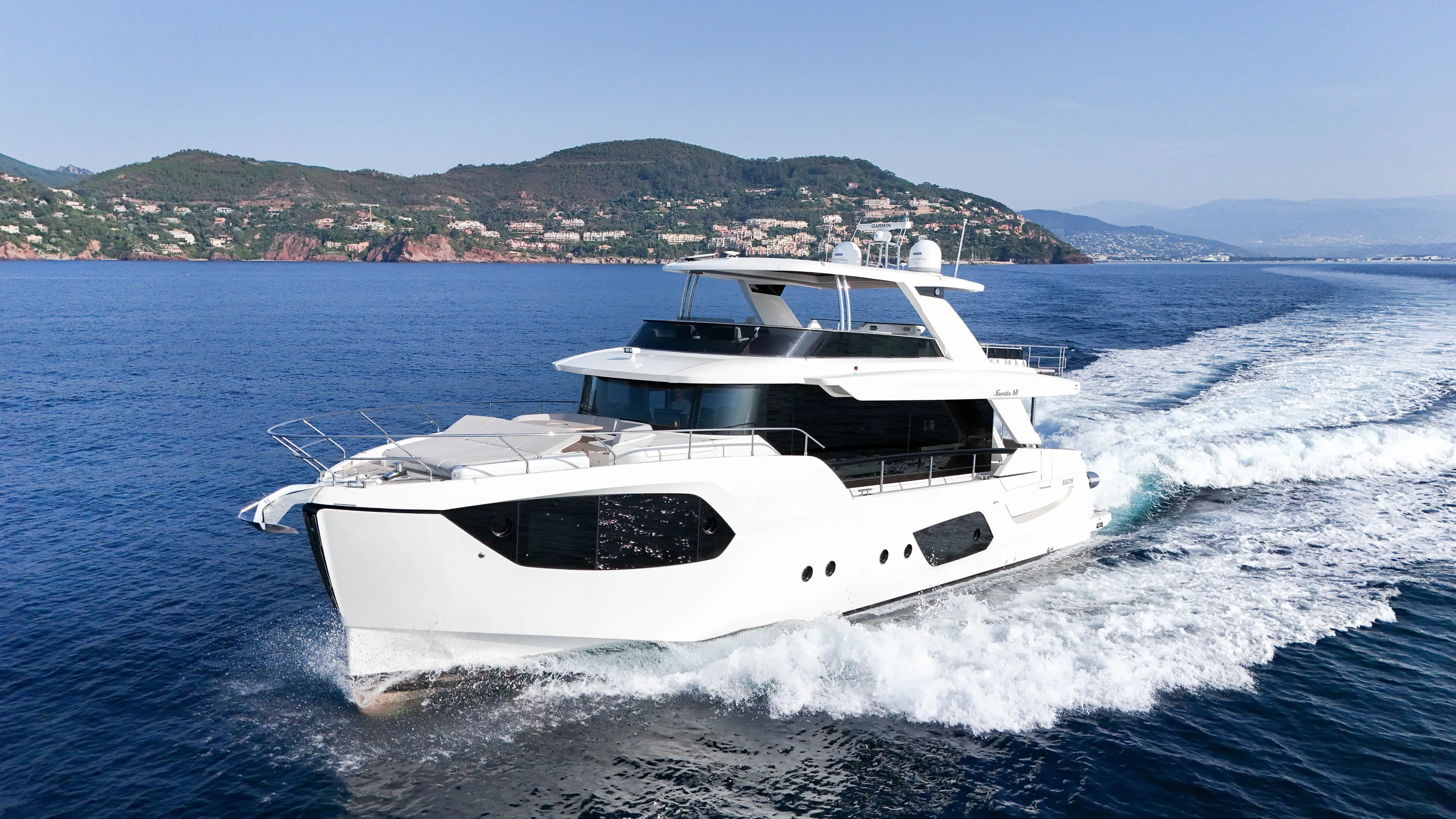  Yacht Photos Pics 2023 Absolute Navetta 68 yacht cruising on blue ocean near scenic coastline.