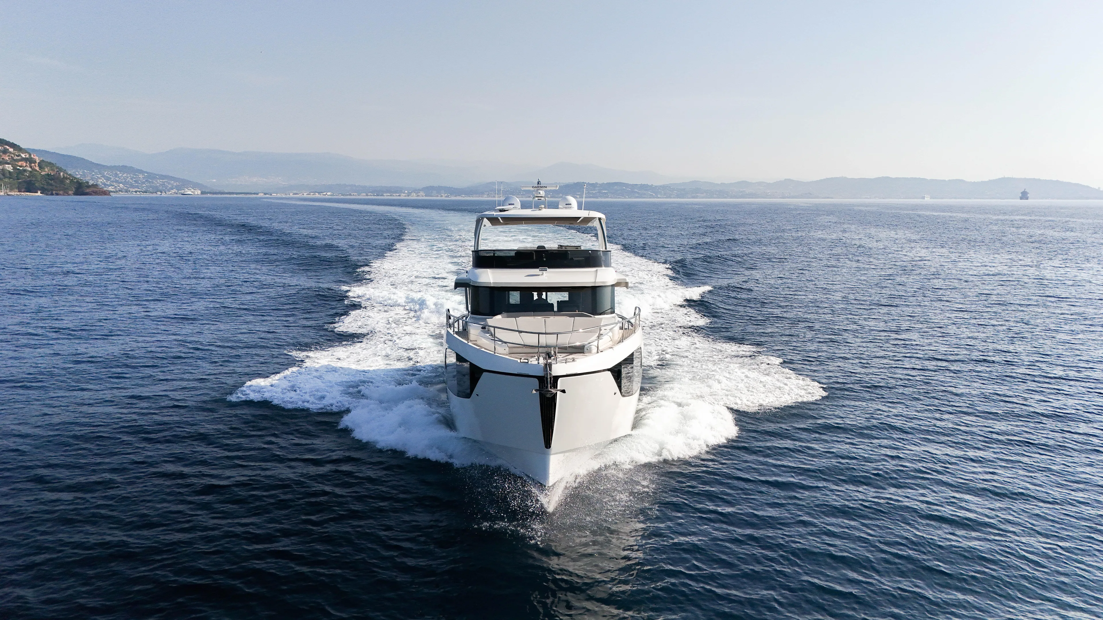  Yacht Photos Pics 2023 Absolute Navetta 68 yacht cruising on open sea, leaving a wake behind.