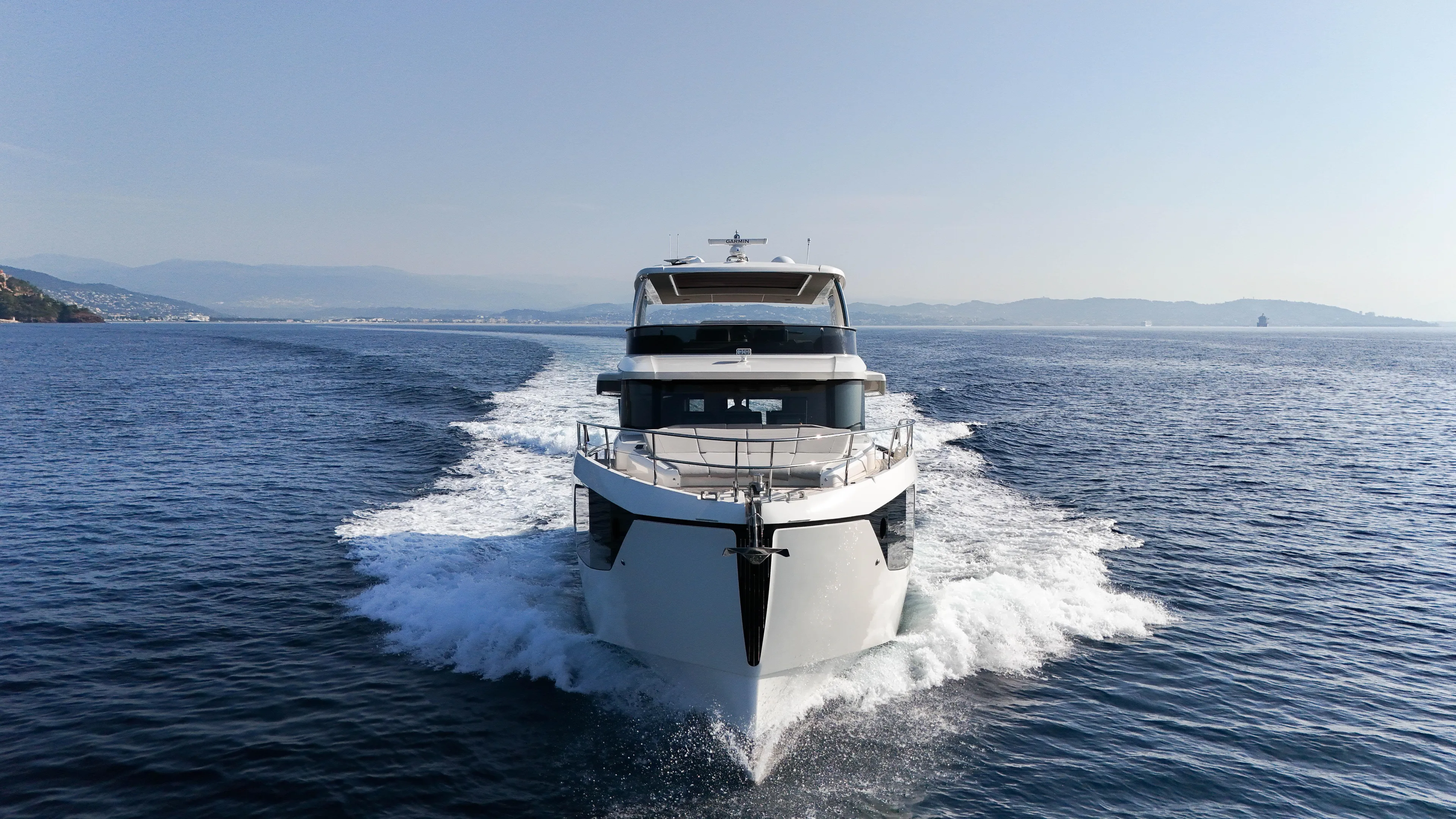  Yacht Photos Pics 2023 Absolute Navetta 68 yacht cruising on open sea, front view.