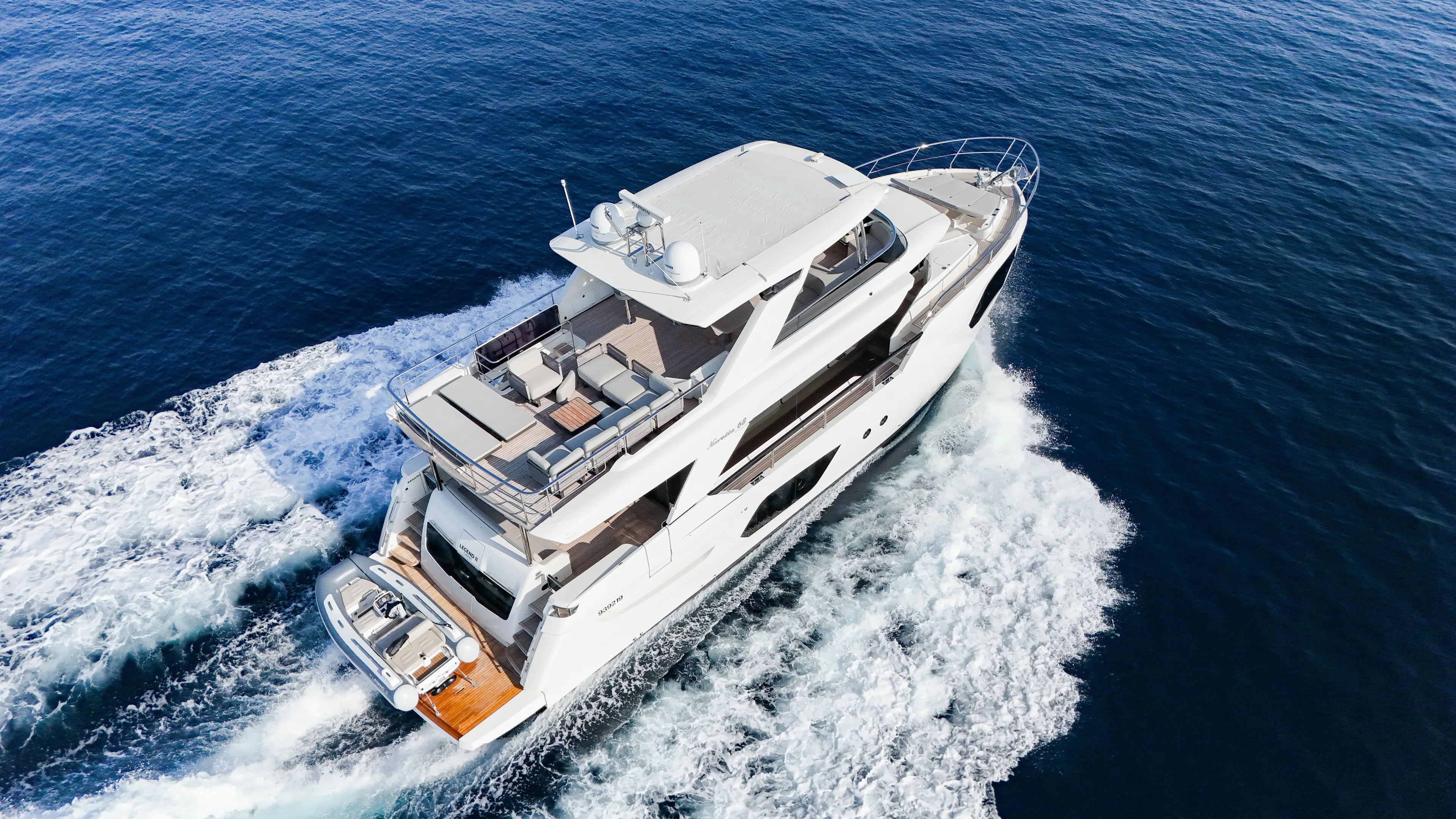  Yacht Photos Pics 2023 Absolute Navetta 68 yacht cruising on open sea, aerial view.
