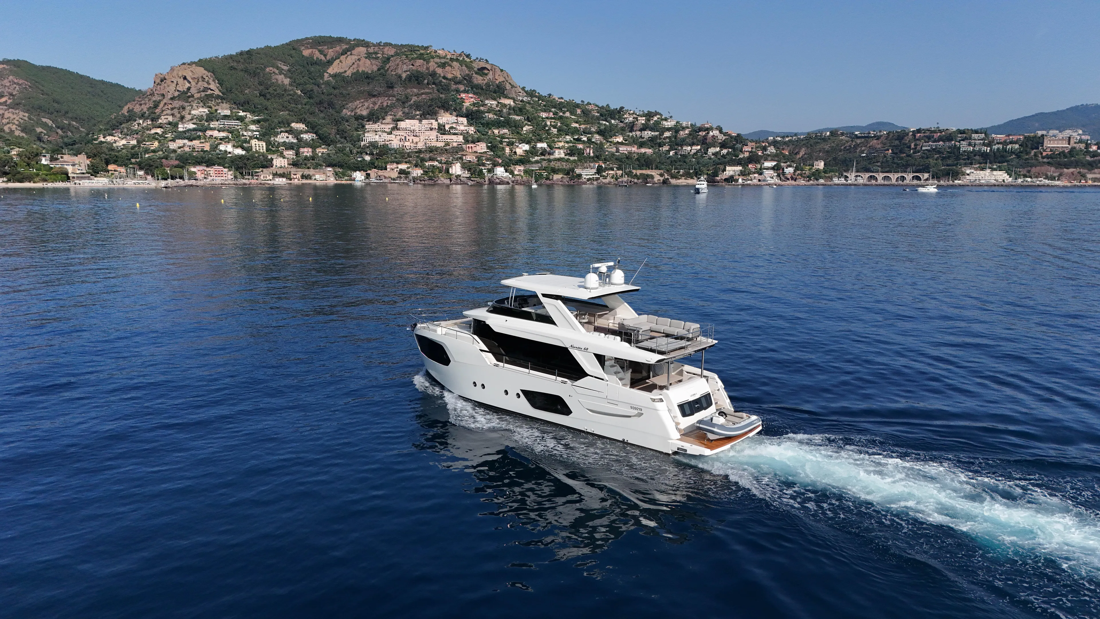  Yacht Photos Pics 2023 Absolute Navetta 68 yacht cruising near scenic coastal landscape.