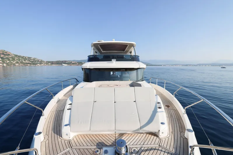  Yacht Photos Pics 2023 Absolute Navetta 68 yacht on calm sea, showcasing luxurious deck and scenic coastal view.