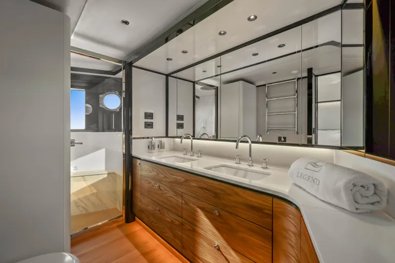  Yacht Photos Pics Luxurious bathroom in 2023 Absolute Navetta 68 yacht with dual sinks and elegant wood cabinetry.