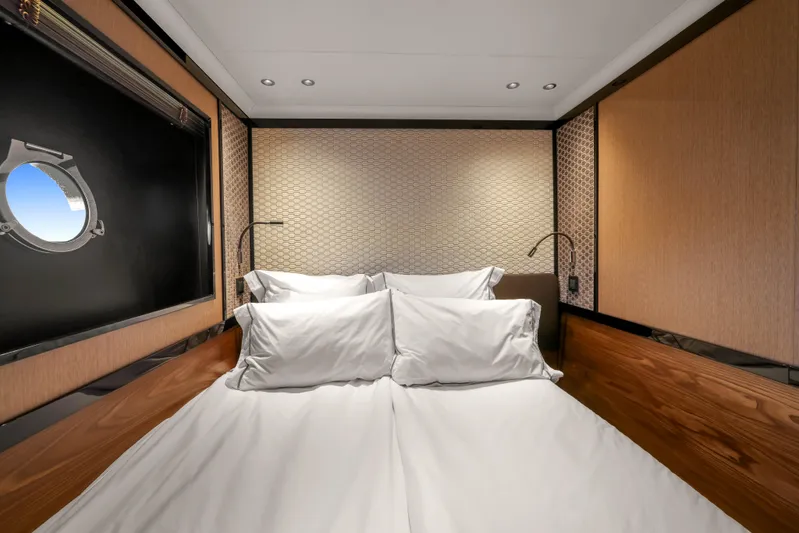  Yacht Photos Pics Luxurious cabin interior of 2023 Absolute Navetta 68 yacht with elegant bedding and porthole view.
