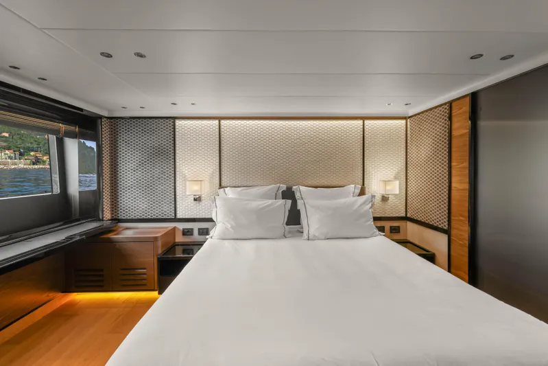  Yacht Photos Pics Luxurious bedroom interior of 2023 Absolute Navetta 68 yacht with elegant design and scenic window view.