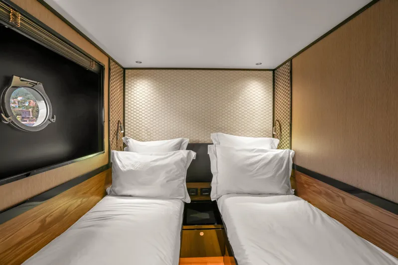  Yacht Photos Pics Luxurious twin cabin interior on 2023 Absolute Navetta 68 yacht with porthole view.