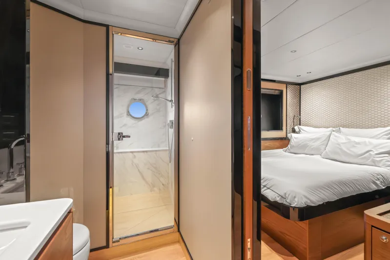  Yacht Photos Pics Luxurious bedroom and bathroom on 2023 Absolute Navetta 68 yacht, featuring elegant design and comfort.