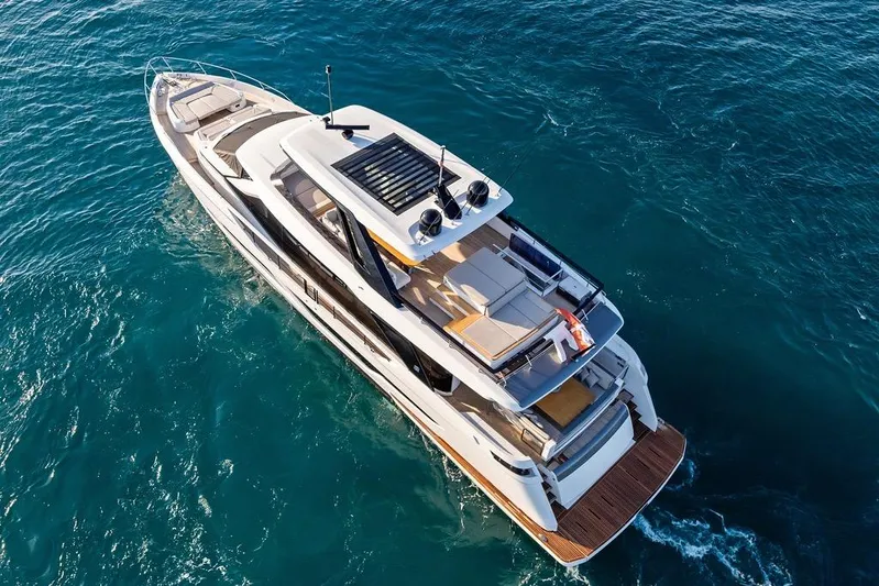  Yacht Photos Pics 2023 Ferretti Yachts 860 cruising on clear blue ocean waters.