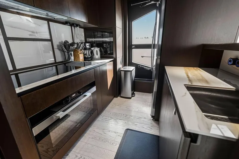  Yacht Photos Pics Luxurious kitchen interior of 2023 Ferretti Yachts 860, featuring modern appliances and sleek design.