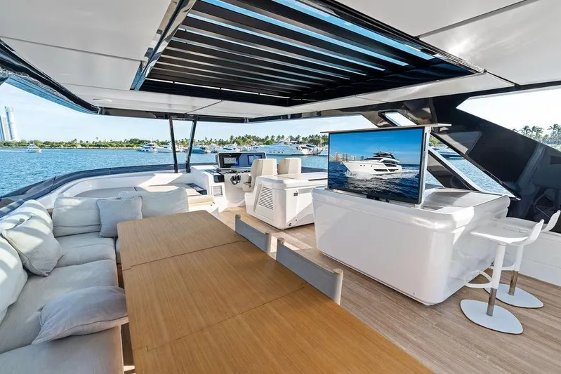  Yacht Photos Pics Luxurious 2023 Ferretti Yachts 860 interior with modern seating, TV, and ocean view.