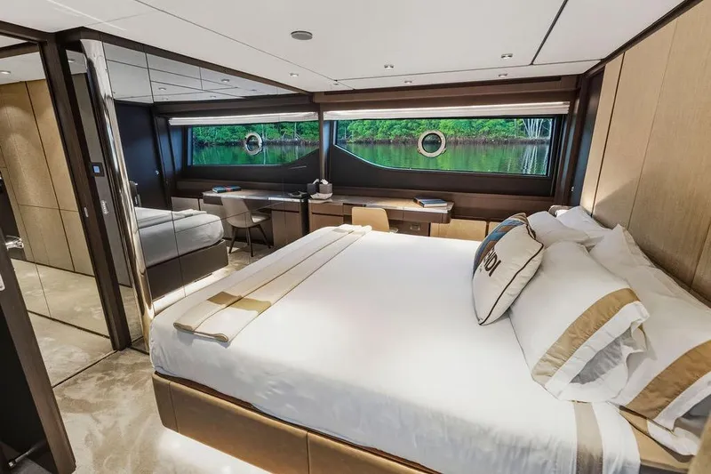  Yacht Photos Pics Luxurious bedroom interior of 2023 Ferretti Yachts 860 with elegant furnishings and scenic window view.