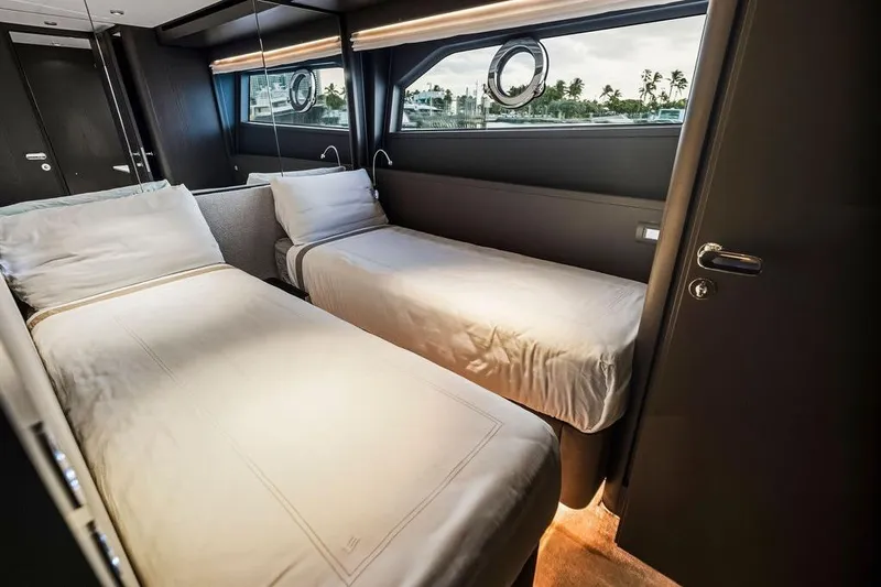  Yacht Photos Pics Luxurious twin bedroom in 2023 Ferretti Yachts 860, featuring modern design and porthole view.