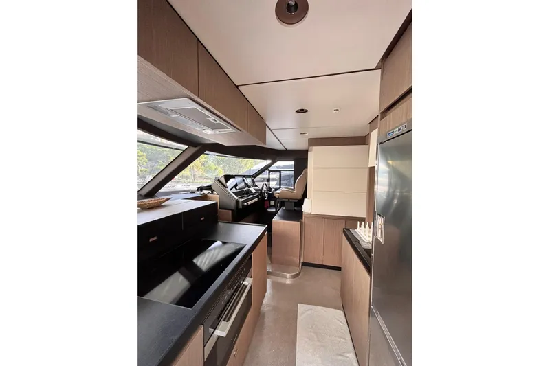  Yacht Photos Pics Luxurious interior of 2025 Benetti Azimut MAGELLANO 66 yacht, featuring modern kitchen and helm.