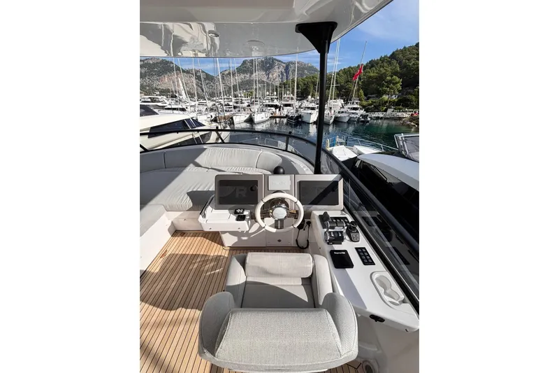  Yacht Photos Pics Luxurious 2025 Benetti Azimut MAGELLANO 66 yacht helm with modern controls, docked in scenic marina.