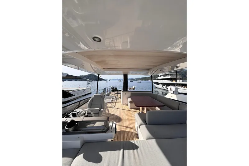  Yacht Photos Pics Luxurious 2025 Benetti Azimut MAGELLANO 66 yacht interior with elegant seating and scenic ocean view.
