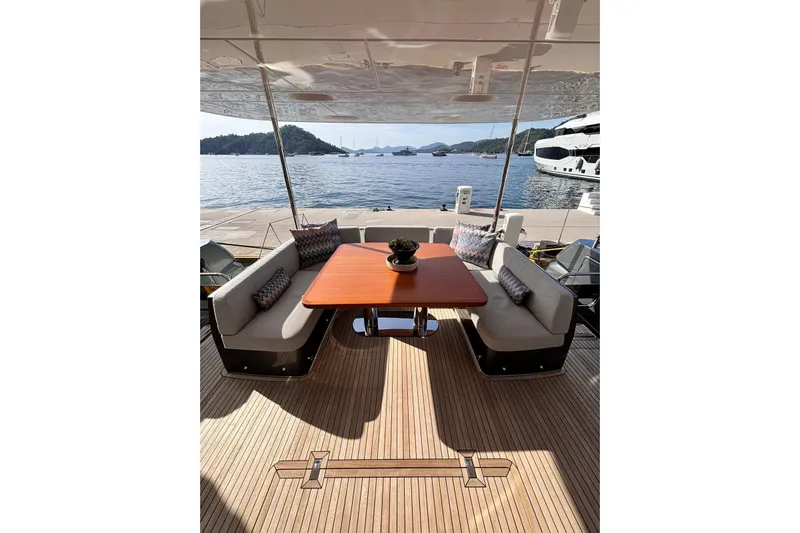  Yacht Photos Pics Luxurious 2025 Benetti Azimut MAGELLANO 66 yacht deck with elegant seating and scenic ocean view.