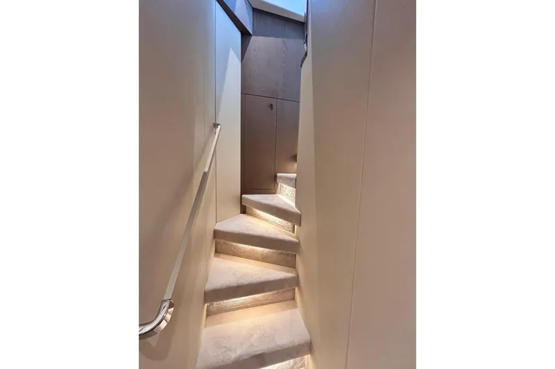  Yacht Photos Pics Elegant staircase inside 2025 Benetti Azimut MAGELLANO 66 yacht, featuring modern design and ambient lighting.